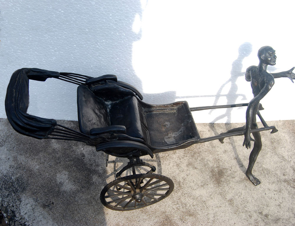 Song of the Road : A man happily pulling the yesteryears hand rickshaw; figurative, bronze, by Modern Master KS Radhakrishnan